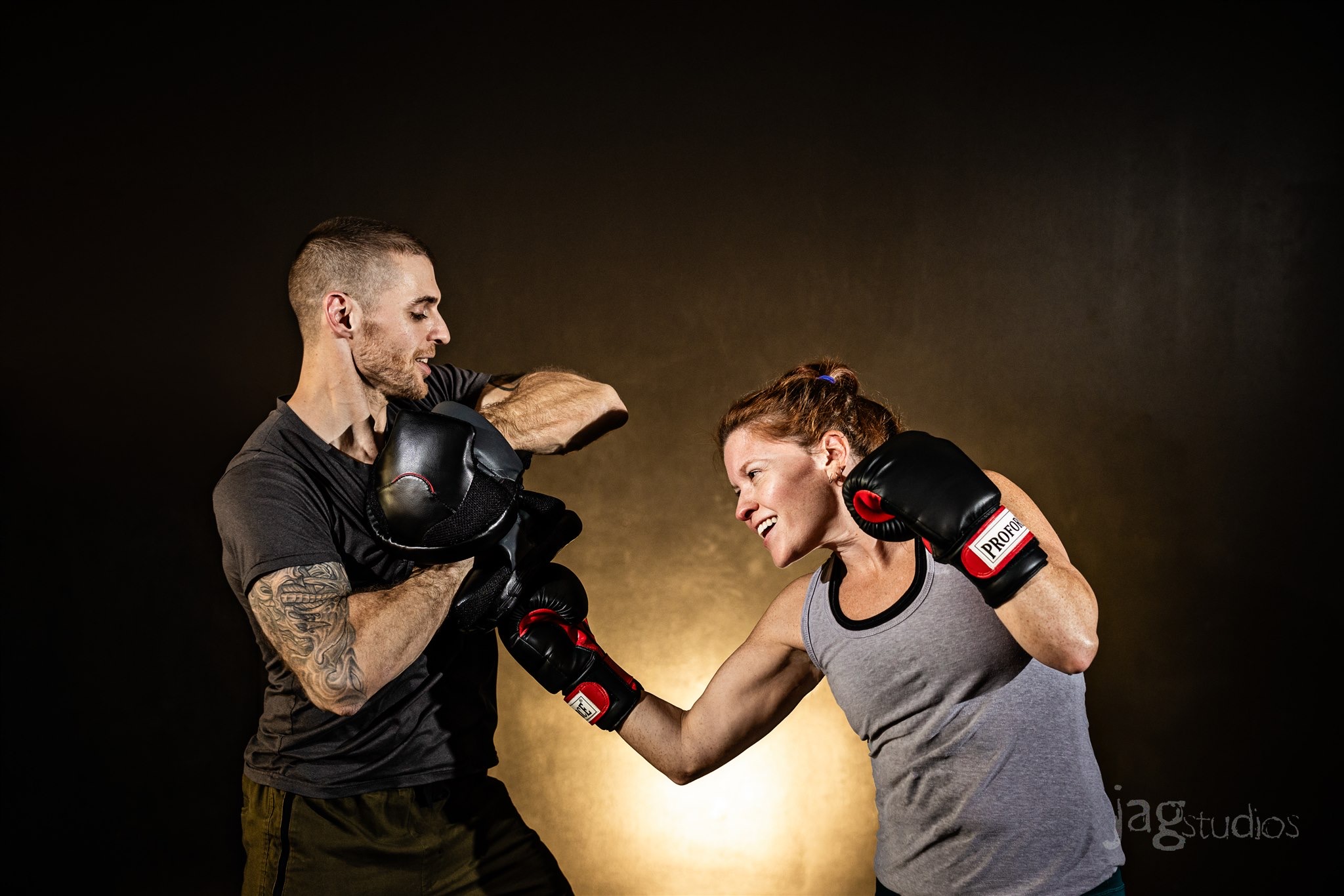 Coach Jon working mitts with a member at Fire Inside Fitness